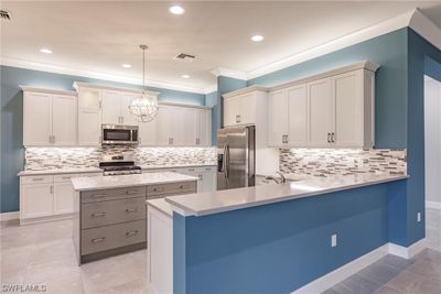 Be sure to take notice of the backsplash that is accented by the illuminating under cabinet lights......sweet! | Image 2