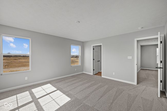 unfurnished bedroom featuring carpet, baseboards, and a textured ceiling | Image 25