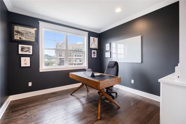 Main Floor Home Office contains built-in bookcases, hardwood floor, recessed lights and double glass doors for privacy. | Image 18