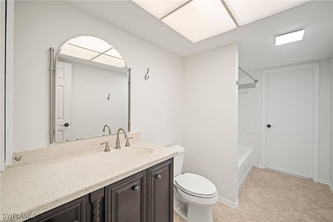 Full bathroom with vanity, tile patterned flooring, and bathtub / shower combination | Image 17