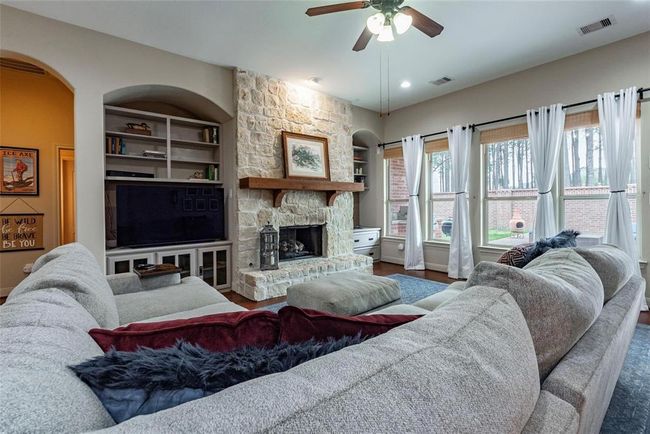 Spacious living room with built-in entertainment nook, high ceilings, wall-of-windows with backyard views. | Image 30