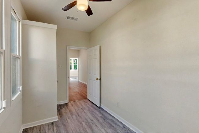 Empty room featuring wood finished floors, ceiling fan, and baseboards | Image 11