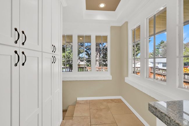Mudroom with a raised ceiling, baseboards, recessed lighting, crown molding, and light tile patterned floors | Image 11