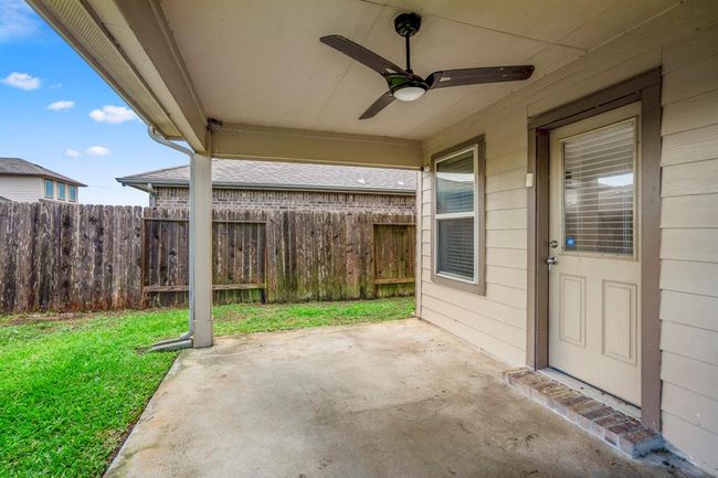 There is a covered patio with an outdoor ceiling fan. | Image 43