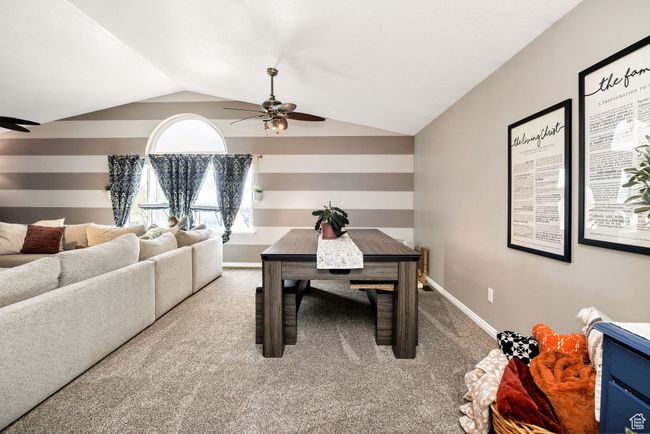 Dining area with vaulted ceiling, carpet, baseboards, and ceiling fan | Image 15