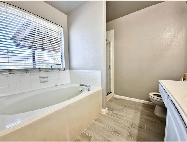 Full bathroom featuring vanity, a garden tub, and a shower stall | Image 16