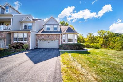 View of front of home with a balcony, a garage, and a front lawn | Image 2