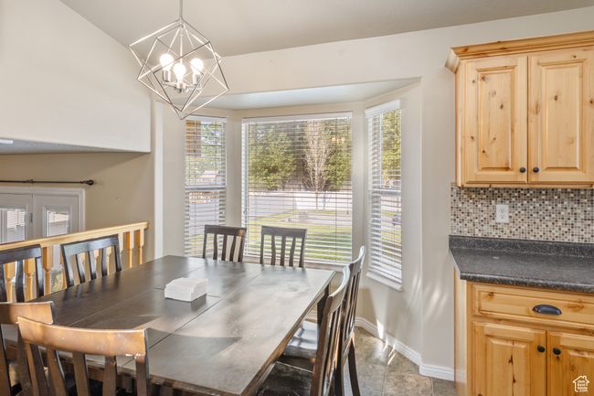 Dining room featuring a chandelier and stone finish flooring | Image 10