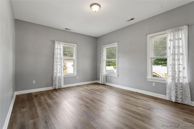 Unfurnished room featuring wood finished floors and baseboards | Image 20