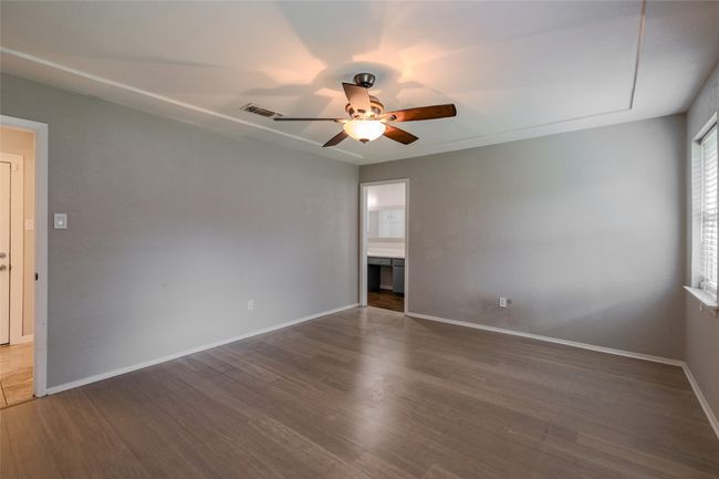 Spare room featuring a ceiling fan and wood finished floors | Image 16