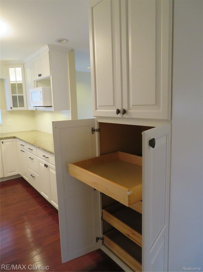 Pantry cabinet has pull out drawers. | Image 7