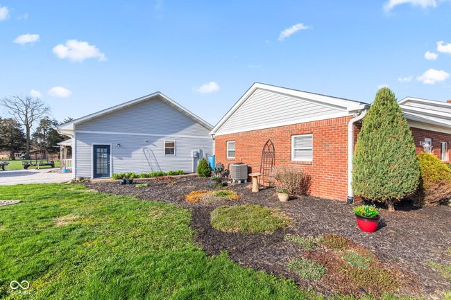 view of side of property featuring a yard, brick siding, and cooling unit | Image 48