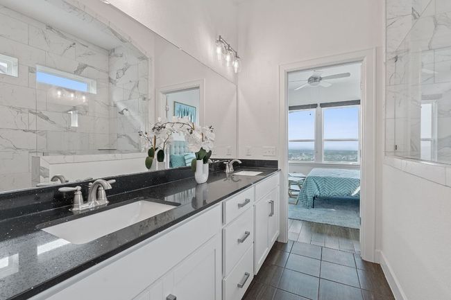 The primary ensuite bathroom boasts a spacious dual vanity with premium countertop and Shaker-style cabinetry. | Image 21