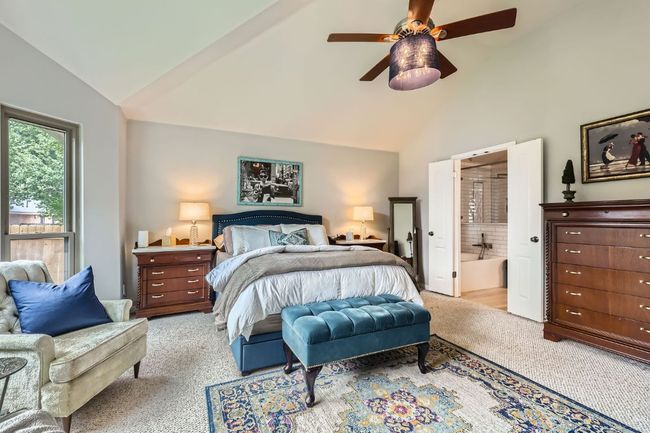 Bedroom with light carpet, ensuite bath, high vaulted ceiling, and ceiling fan | Image 12