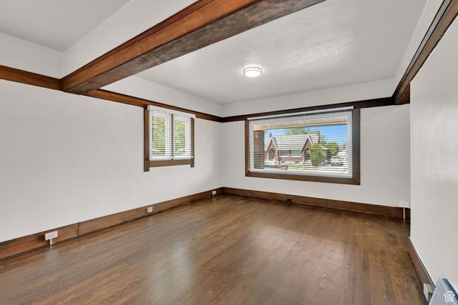 Unfurnished room featuring dark wood finished floors and baseboards | Image 8