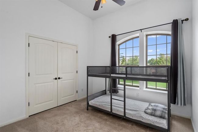 Carpeted bedroom featuring baseboards, ceiling fan, and a closet | Image 28