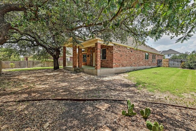 View of home's exterior featuring brick siding, a fenced backyard, and a patio | Image 35