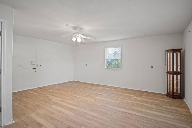 Spare room with ceiling fan and light wood-style flooring | Image 15