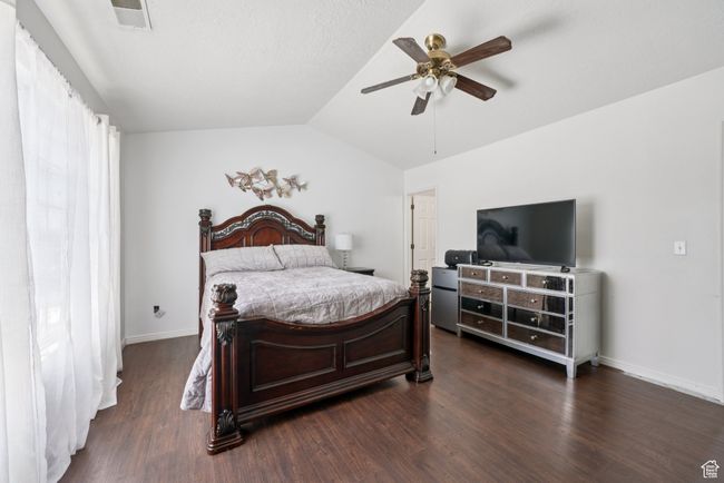 Bedroom featuring lofted ceiling, dark wood-type flooring, and a ceiling fan | Image 16