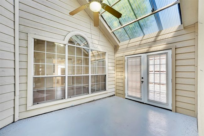 Unfurnished sunroom with ceiling fan and vaulted ceiling | Image 21