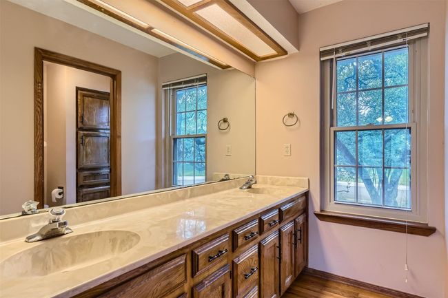 Full bath with vanity opening to area with commode and tub and shower combination | Image 15