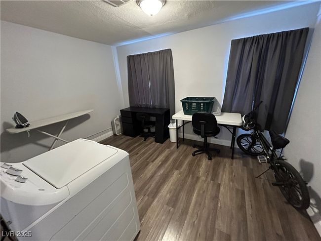 Office area with wood finished floors and a textured ceiling | Image 22