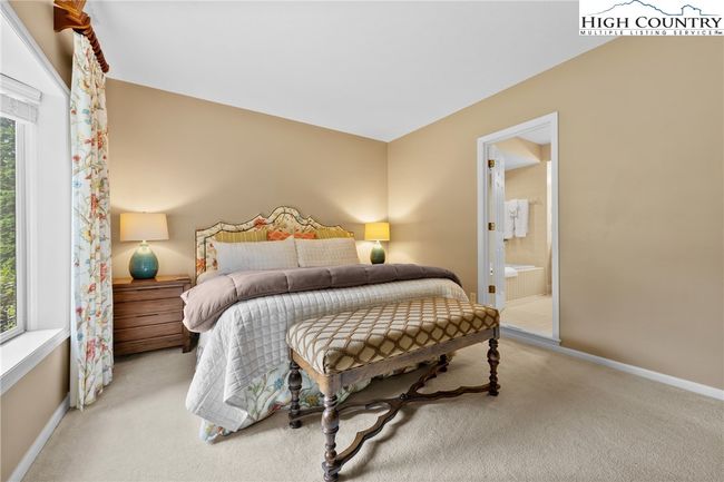Primary bedroom is an oasis with views of the vast lawn | Image 13