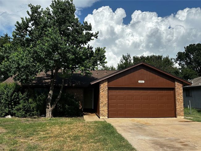 View of front of property with brick siding, driveway, a garage, roof with shingles, and a front yard | Image 4
