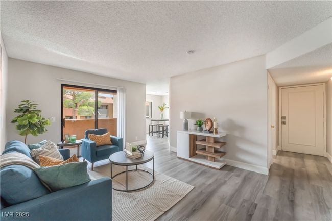 Living area featuring wood finished floors and a textured ceiling | Image 4