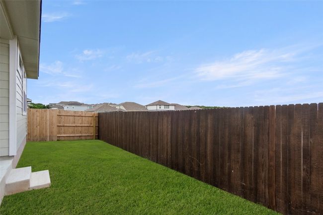 View of fenced backyard | Image 35