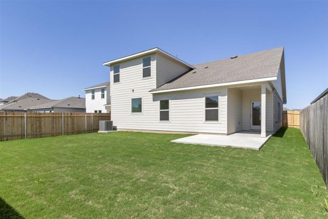 Rear view of property featuring a patio, a fenced backyard, central AC unit, and a lawn | Image 31