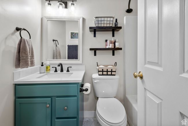 Full bathroom with vanity and marble look tile flooring | Image 25