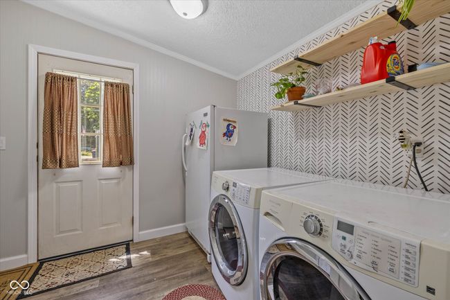 An oversized laundry room with newer shelving. | Image 11