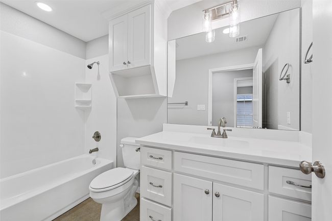 Full bath featuring visible vents, toilet, shower / bathing tub combination, and vanity | Image 8
