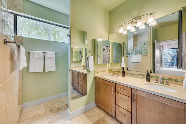 Bathroom featuring vanity, a wealth of natural light, and tasteful backsplash | Image 16