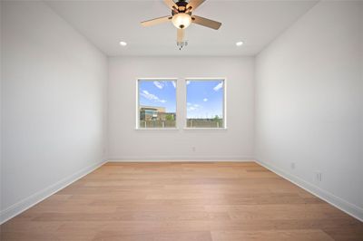 Unfurnished room featuring light wood-type flooring and ceiling fan | Image 3