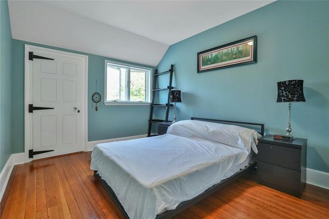Third floor bedroom with vaulted ceiling, walk-in closet and hardwood flooring | Image 31