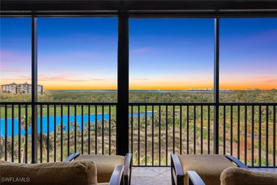 Unfurnished sunroom featuring a water view | Image 1