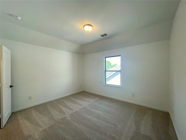 Carpeted empty room with a smoke detector and vaulted ceiling | Image 29