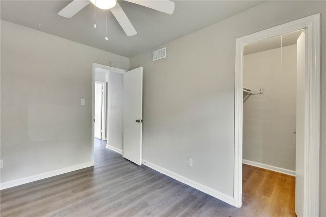 Secondary bedroom with walk-in closet and ceiling fan. | Image 26