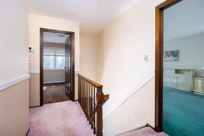 Corridor featuring an upstairs landing, carpet, and a baseboard heating unit | Image 21