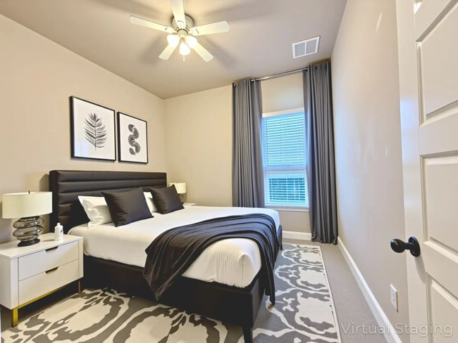 Bedroom featuring light colored carpet and ceiling fan | Image 34