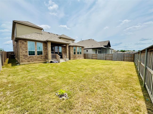 Back of house featuring brick siding and a shingled roof | Image 26