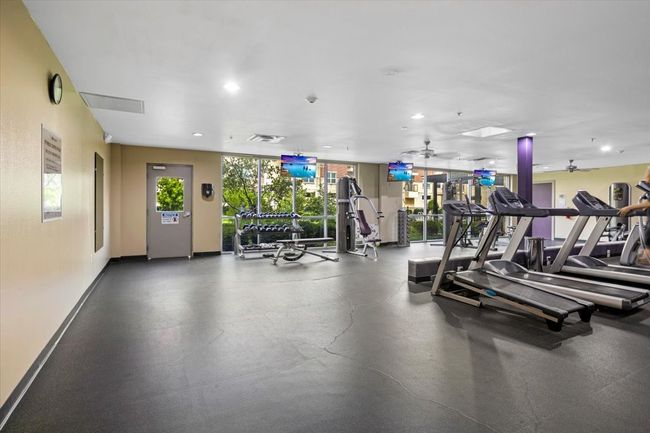 Workout area with a ceiling fan and recessed lighting | Image 8