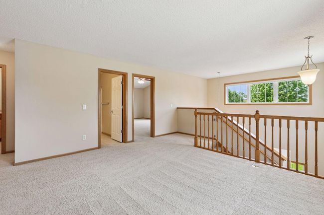 At the top of the stairs is a large loft/upper level family room | Image 10