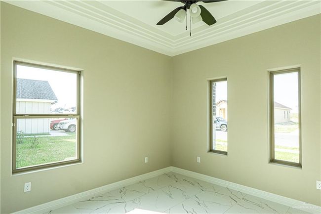 Spare room with marble finish floor, a healthy amount of sunlight, and baseboards | Image 14