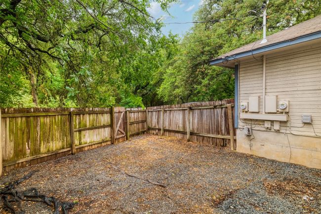 View of fenced backyard | Image 16