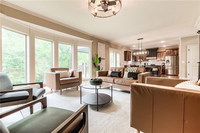 Living area with crown molding and a chandelier | Image 17