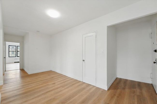 Unfurnished room featuring radiator, baseboards, and light wood-style flooring | Image 13
