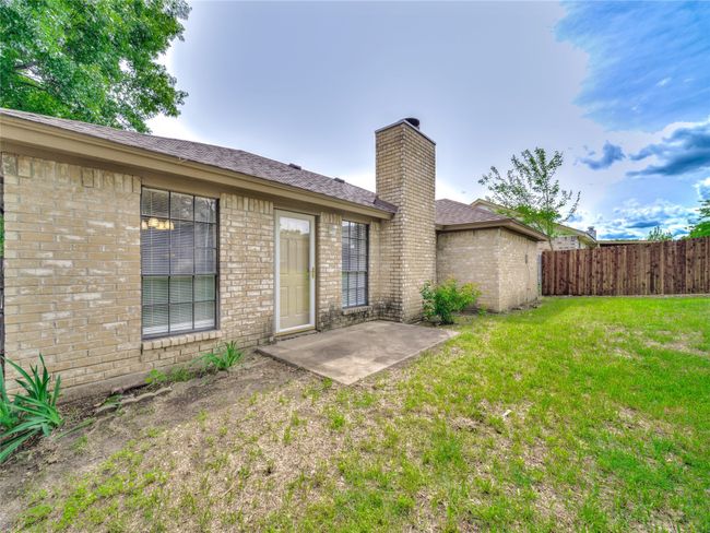 Back of house featuring a chimney, a patio area, and brick siding | Image 23